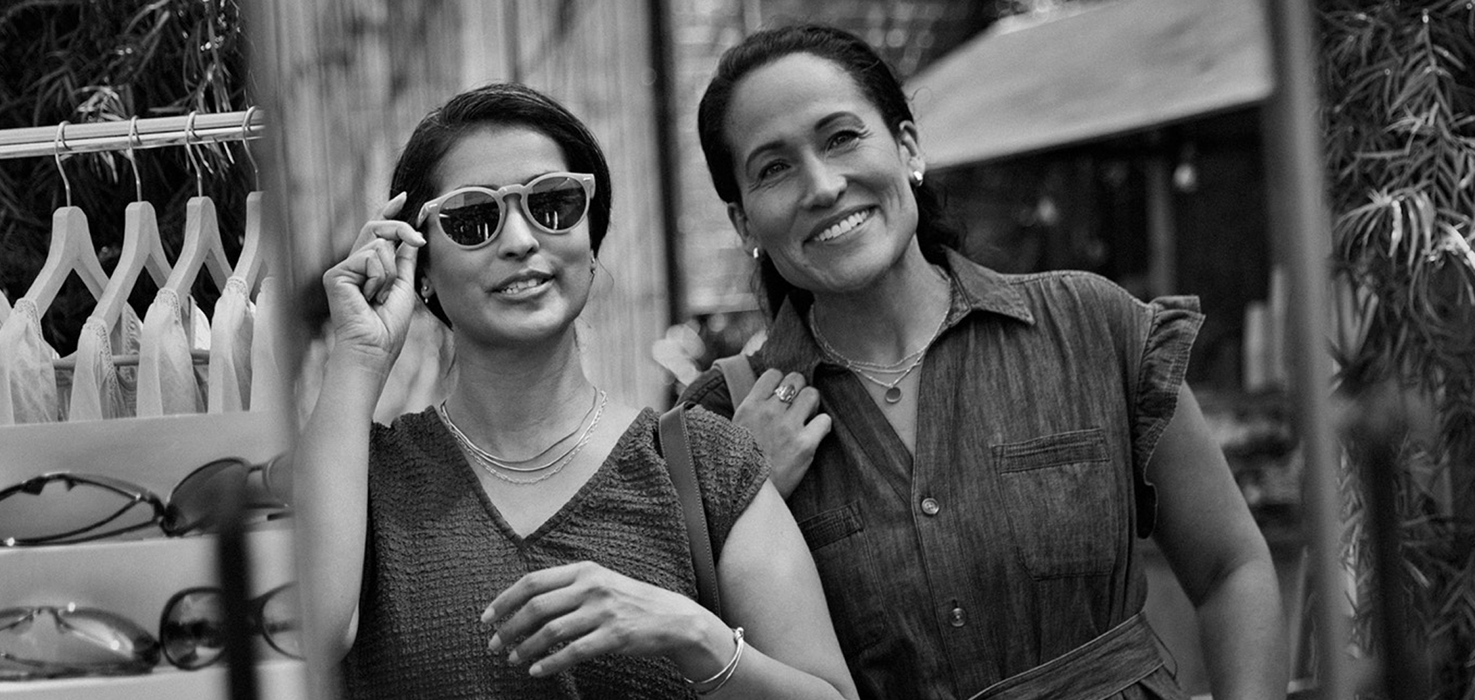 Woman wearing sunglasses with friend