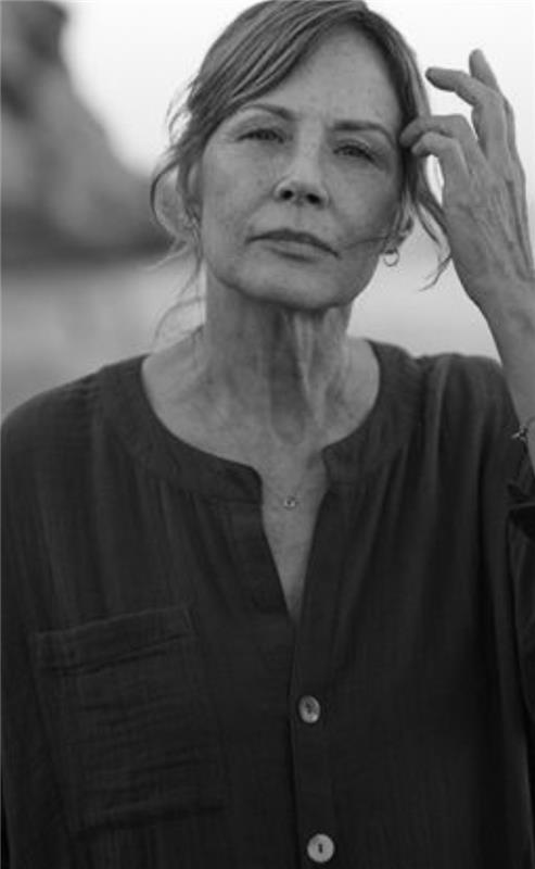 Hopeful woman at beach looking at camera