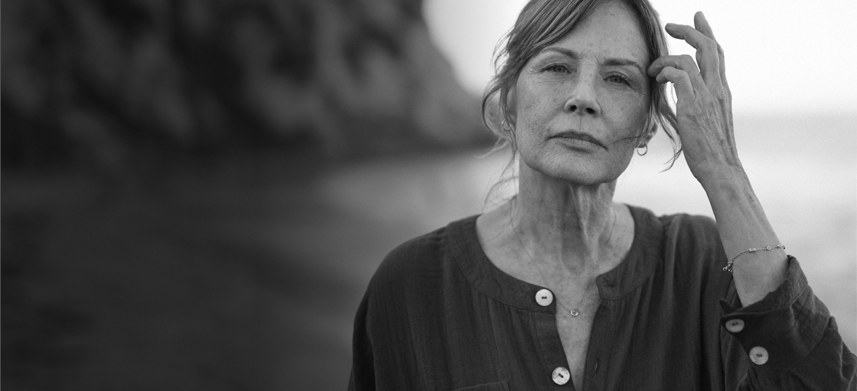 Hopeful woman at beach looking at camera